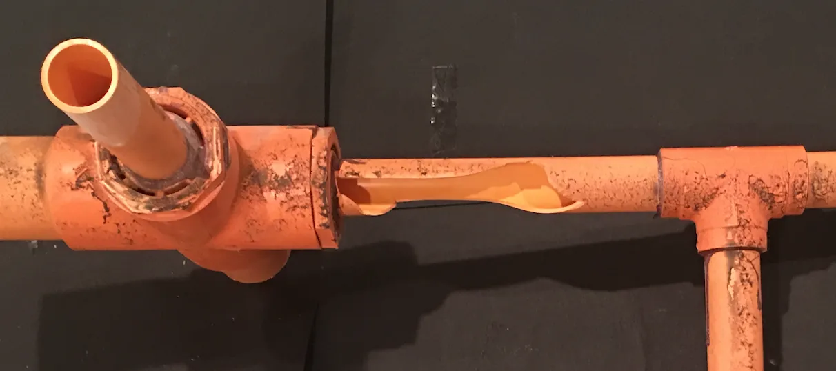 Forensic close-up of a CPVC fire sprinkler pipe crack caused by chemical attack