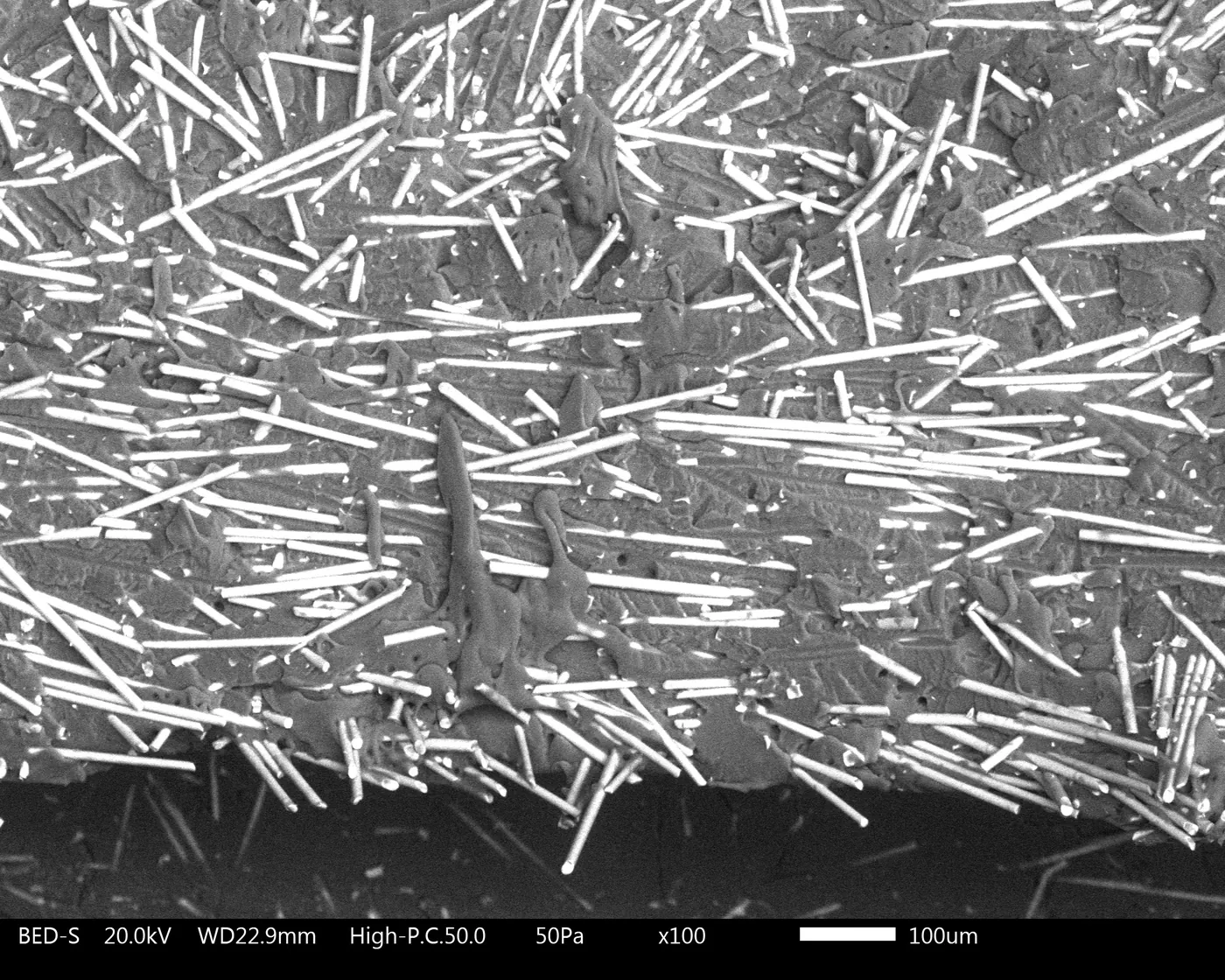 SEM micrograph showing glass fiber orientation parallel to fracture at product knit line defect