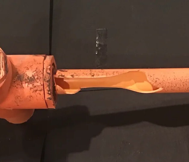 Cracked CPVC pipe fitting showing solvent cement chemical attack and environmental stress cracking