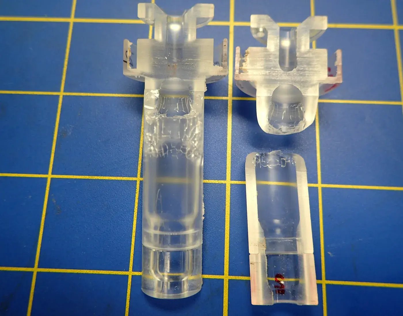 Acrylic plastic syringe specimens showing breakage failure during forensic medical device analysis