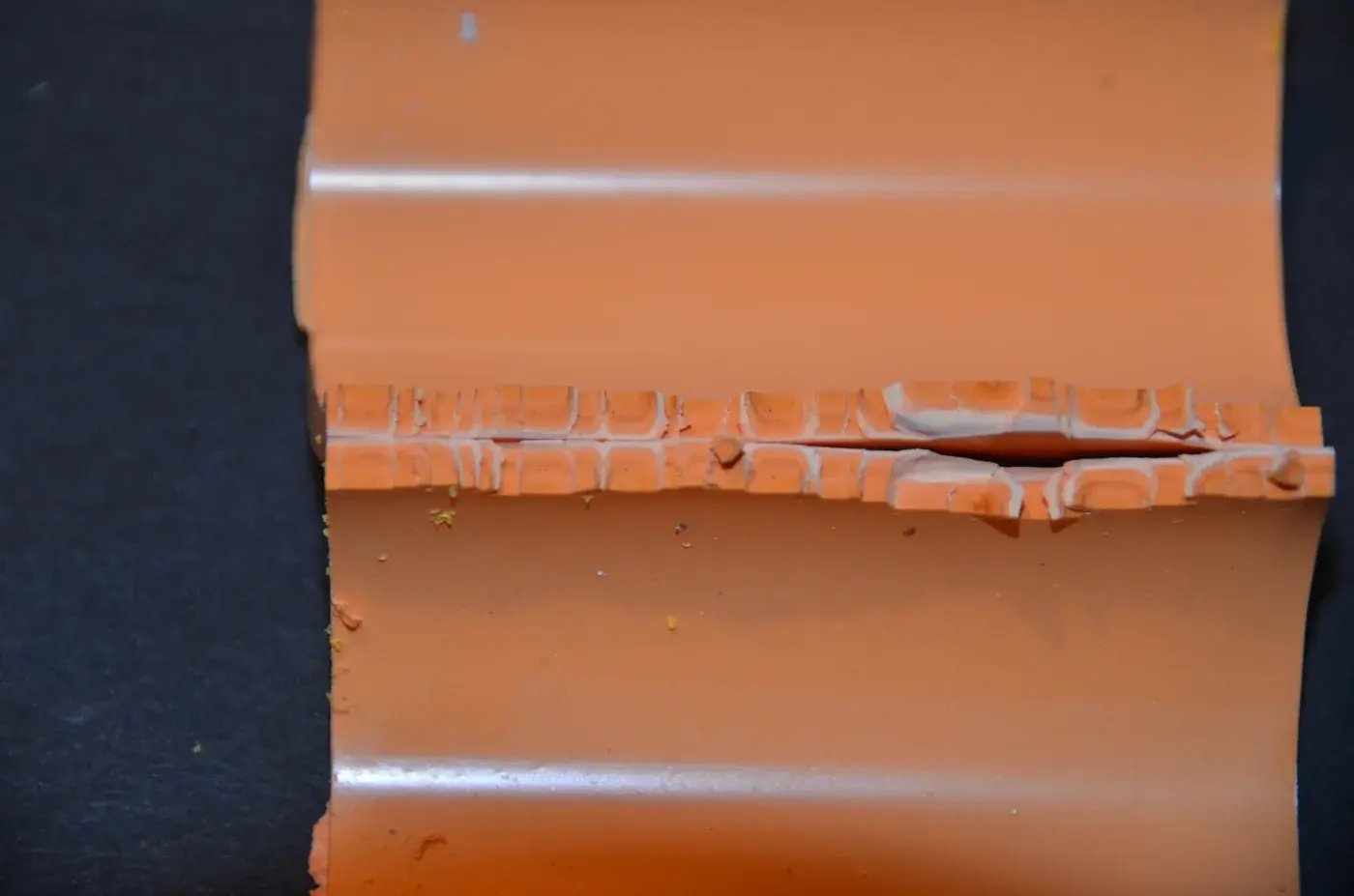 Plastic product fracture along knit line revealing manufacturing defect in forensic analysis