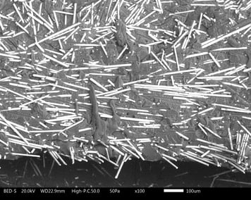 SEM micrograph showing glass fiber orientation parallel to fracture at product knit line defect