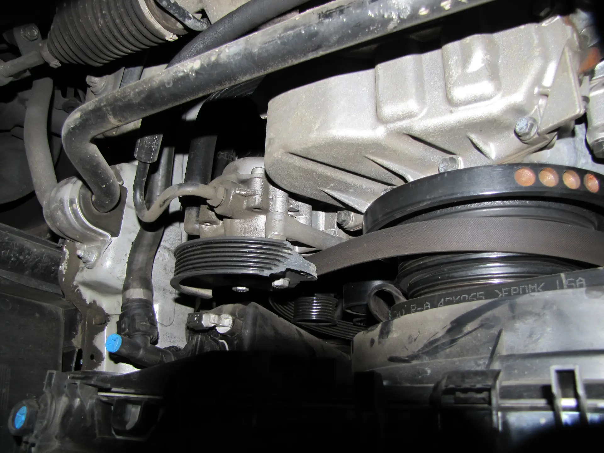 Failed plastic automotive component in engine bay, expert witness analysis of plastic bracket fracture by Plastic Expert Group