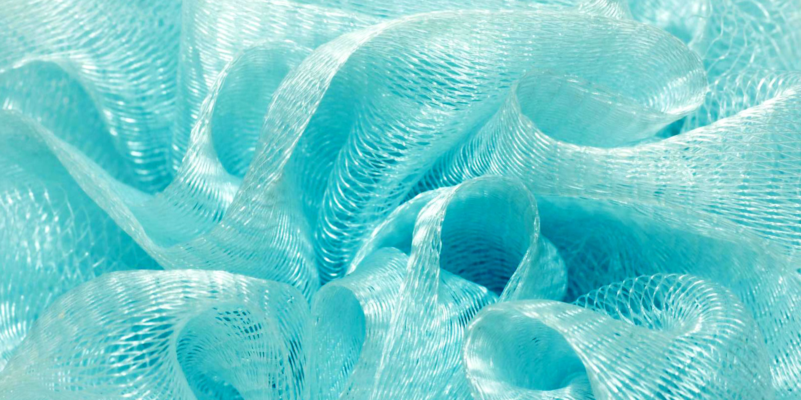Close-up of fine turquoise woven polymer mesh fabric