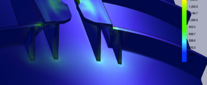 Finite element analysis of the redesigned handle attachment, showing longer support ribs and uniformly low stress across the joint